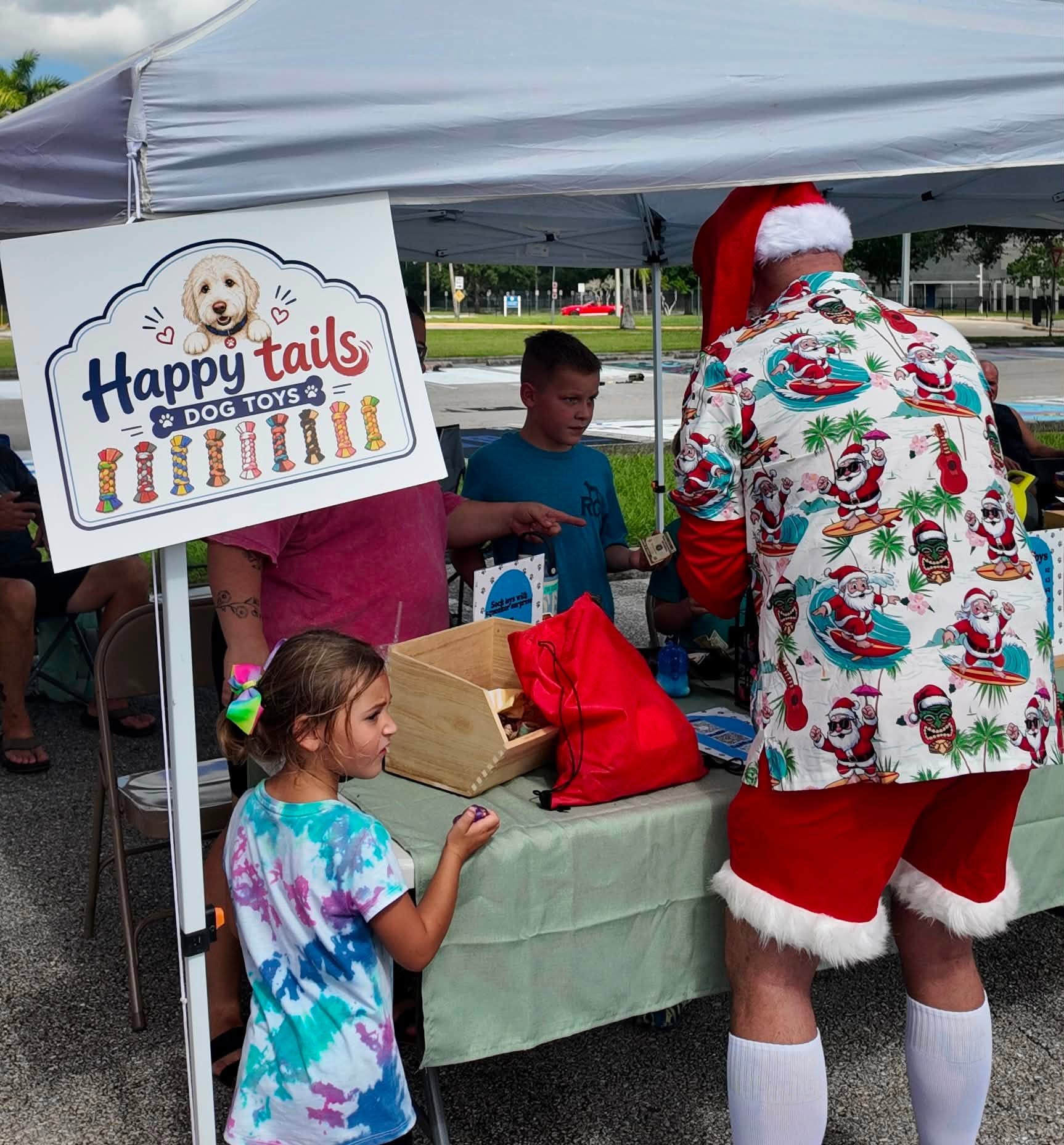 Children picking out handmade dog toys at the Happy Tails stand