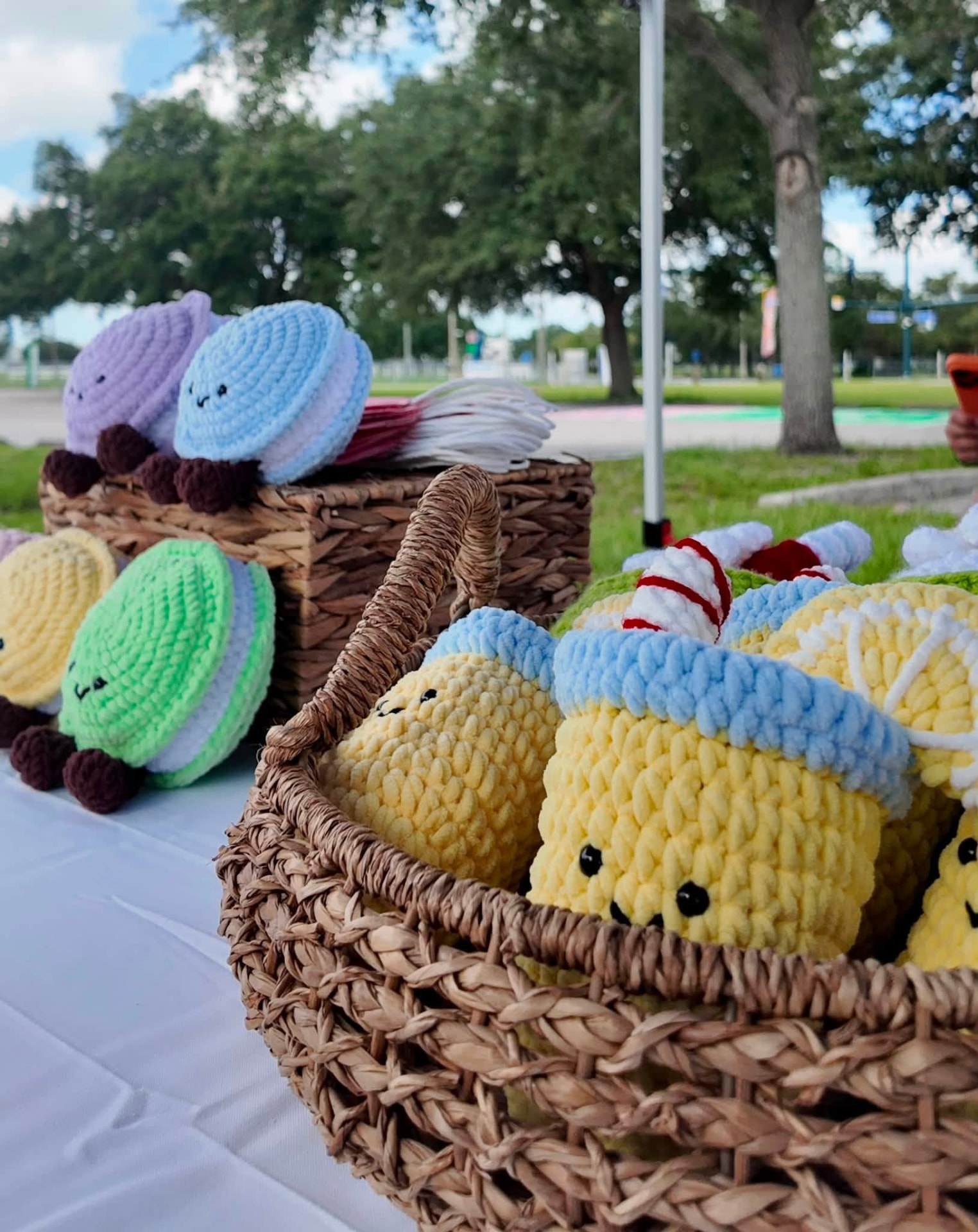 Baskets of crocheted macarons and lemonade plushies with smiling faces